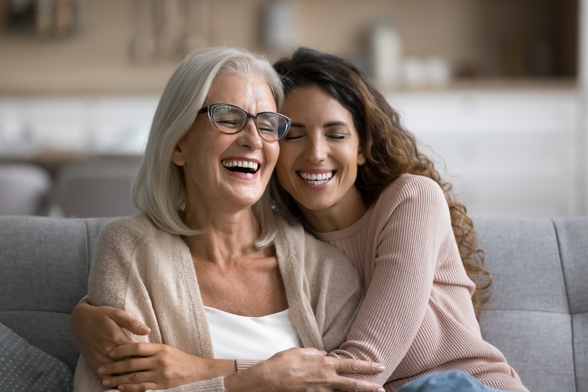 An older woman accompanied by a caregiver at home